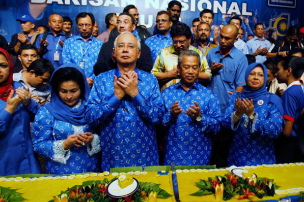 Malaysia's Prime Minister Najib Razak (second from left) celebrates his victory with a prayer on election day in Kuala Lumpur, Malaysia. Photo -- Nicky Loh/Getty Images